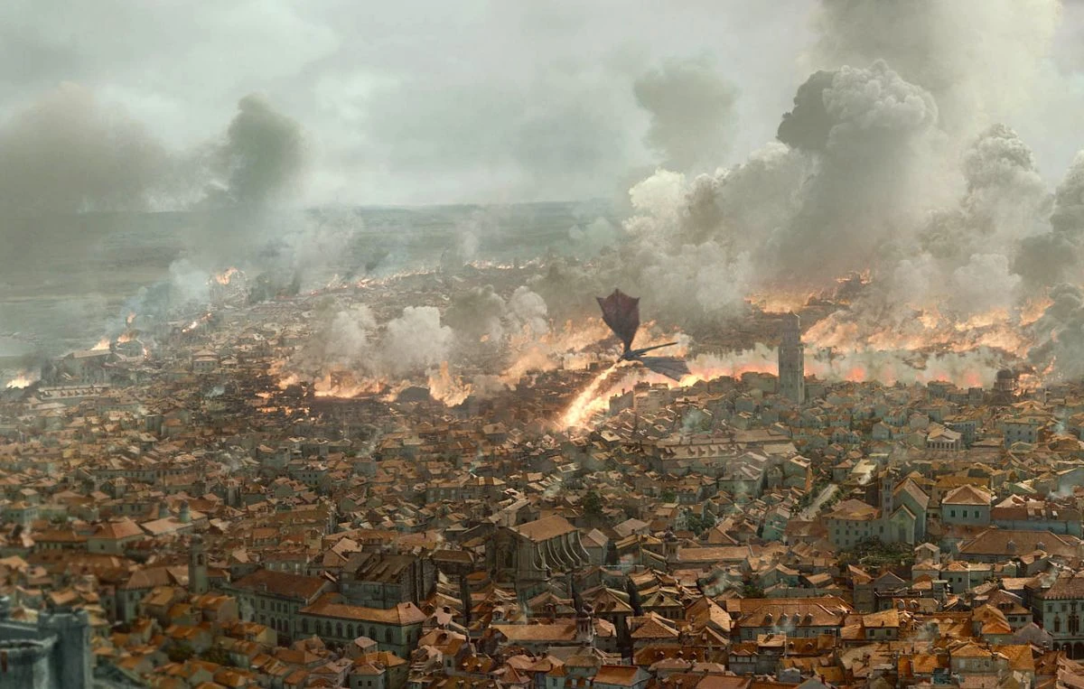 King's Landing engulfed in flames and destruction against dark sky.